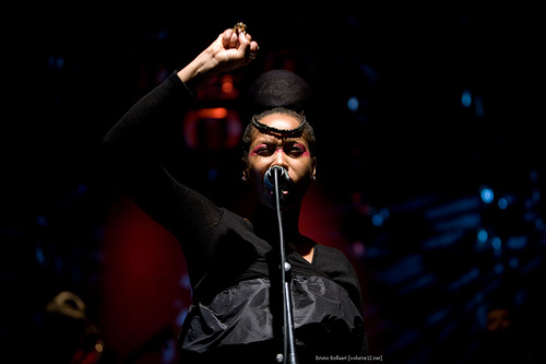 Erykah Badu raises her hand in defiance at a performance at the Gent Jazz Festival in Belgium in 2008.
